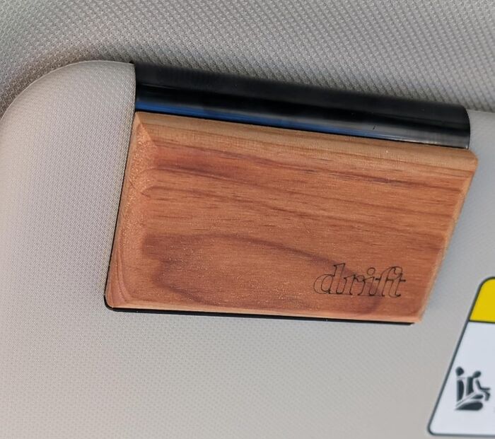 Wooden Drift phone holder attached to a car sun visor, one of Amazon's most wished for unique items.