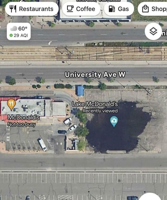 Satellite view of a parking lot showing shenanigans captured on Google Maps with a fake lake labeled McDonald's.