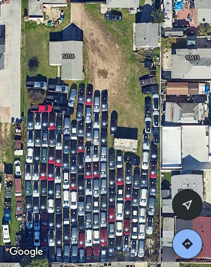 Aerial view of a crowded parking lot showing all sorts of shenanigans captured on Google Maps.