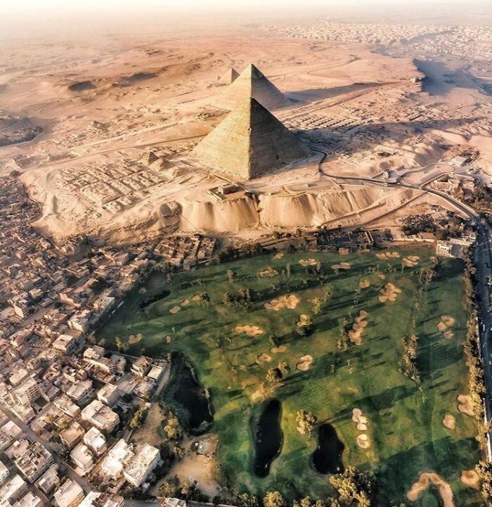 Aerial view of the Great Pyramid of Giza showcasing famous landmarks from unexpected angles in a desert cityscape.