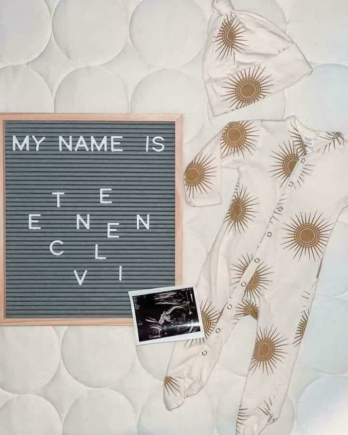 Letter board with the message My Name Is and baby outfit with sun prints next to an ultrasound photo, representing unique baby names.