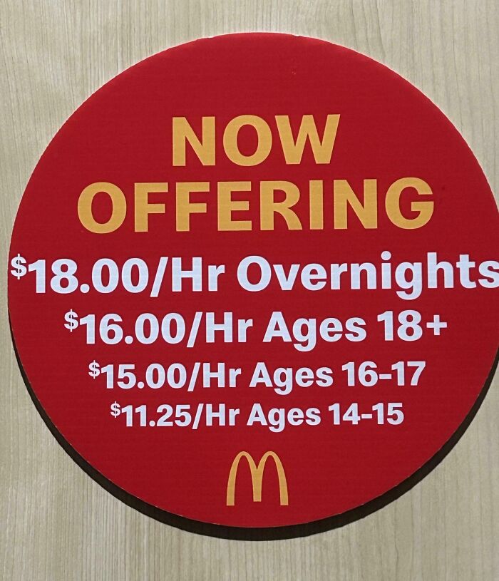 Hiring sign at McDonald's shows low hourly wages, reflecting an extremely toxic work environment for employees.