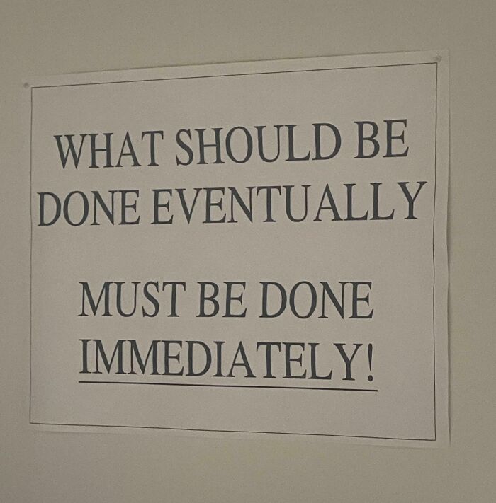 Sign on wall with bold text stating urgent message captured in an extremely toxic work environment photo.