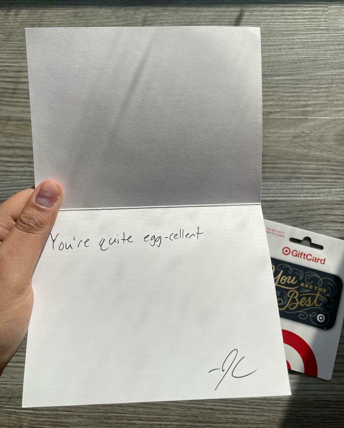 Hand holding a card with a sarcastic note and a gift card, illustrating toxic work environment captured by employees.