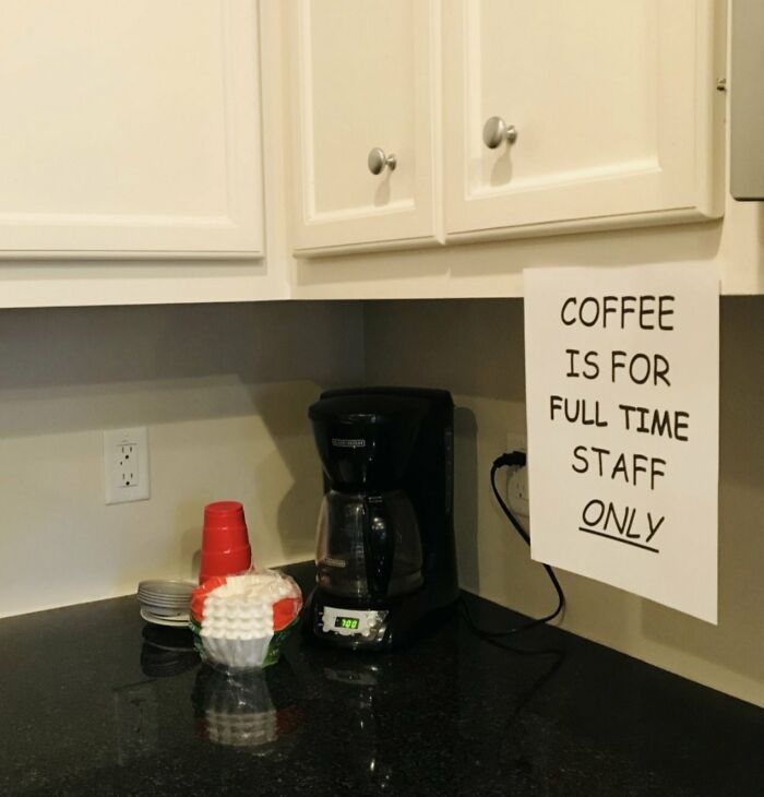 Coffee station with a sign restricting coffee to full time staff in a toxic work environment setting