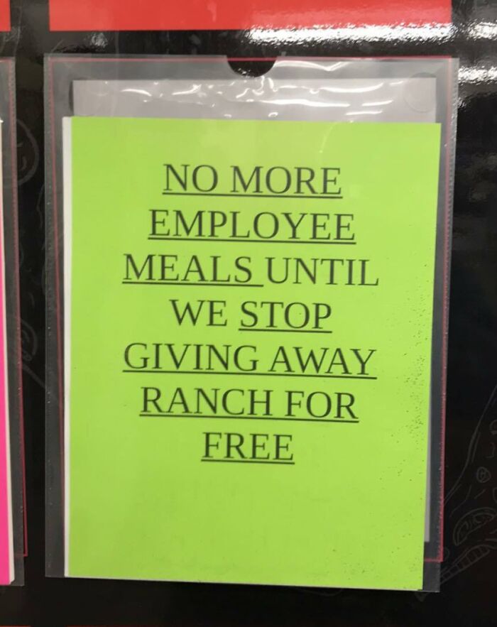 Bright green sign in a toxic work environment stating no more employee meals until ranch is no longer given away for free.