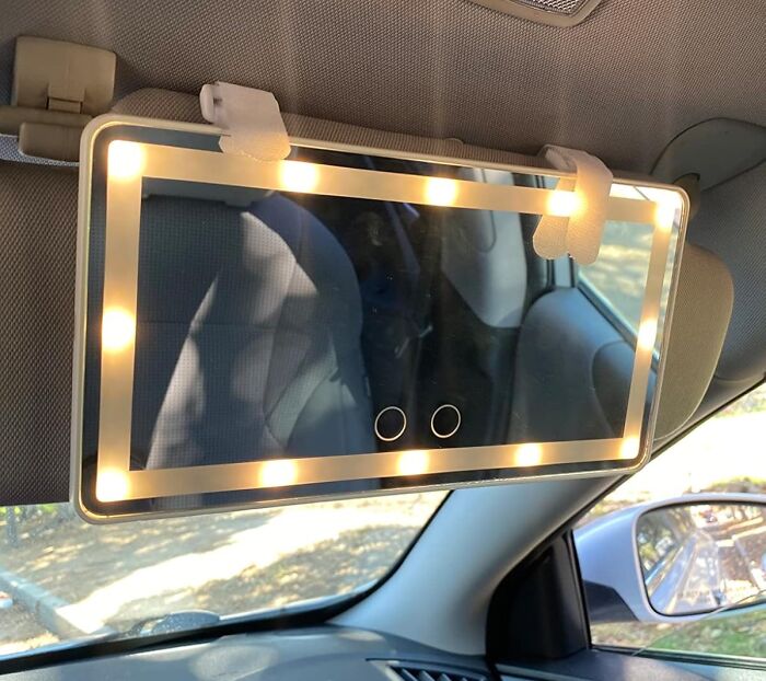LED lighted car visor mirror attached with straps, enhancing commute experience with clever car finds and accessories.