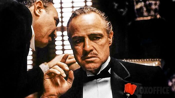 Scene from The Godfather with a man in a tuxedo reflecting on the current situation and lack of peaceful solution.