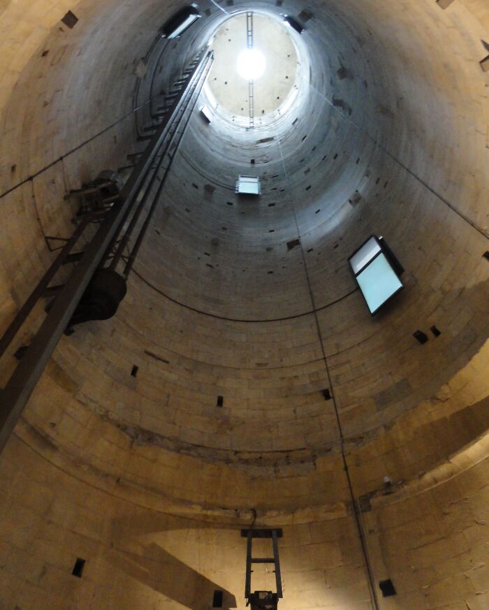 Interior view looking up inside a famous landmark, showcasing an unexpected angle and architectural details.