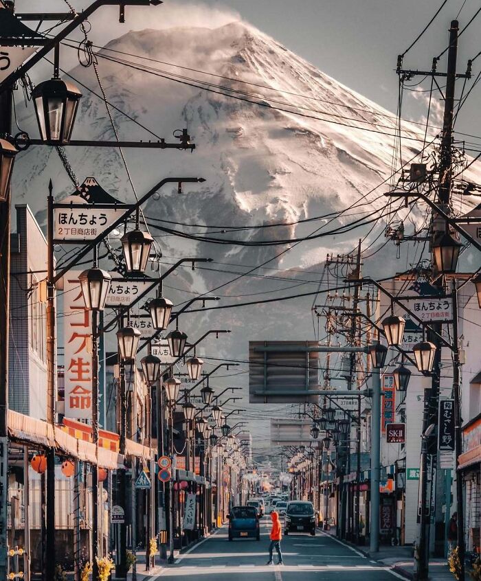 Street view in Japan with Mount Fuji in the background, showcasing famous landmarks from unexpected angles for a unique perspective.
