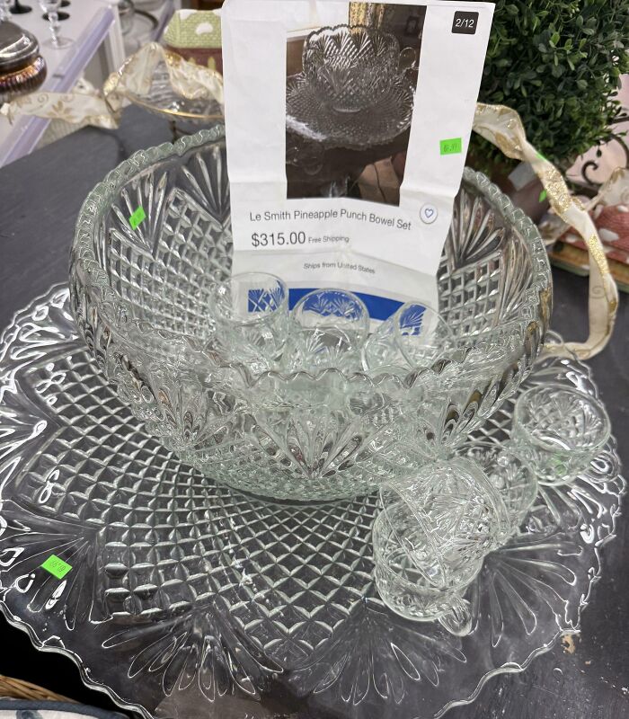 Glass pineapple punch bowl set with cups displayed at thrift store with price tags and product photo insert.
