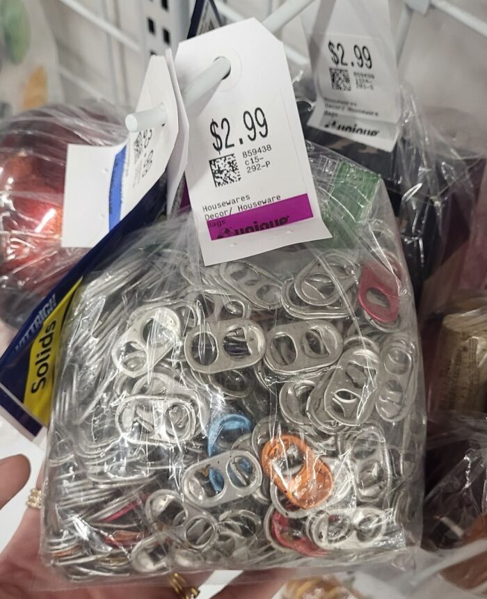 Bag of thrift store sale items containing hundreds of aluminum can tabs priced at $2.99.