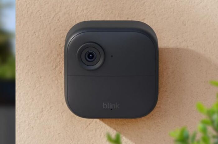 Compact black Blink security camera mounted on an exterior wall, showcasing early Prime Day deals on smart home devices.
