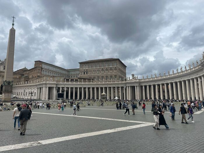 Crowds of travelers walking around a historic plaza, symbolizing inspiring moments of overcoming fear of flying.
