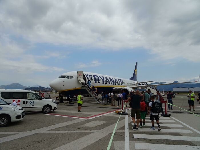 Passengers boarding a Ryanair plane on the tarmac, illustrating inspiring moments overcoming fear of flying.