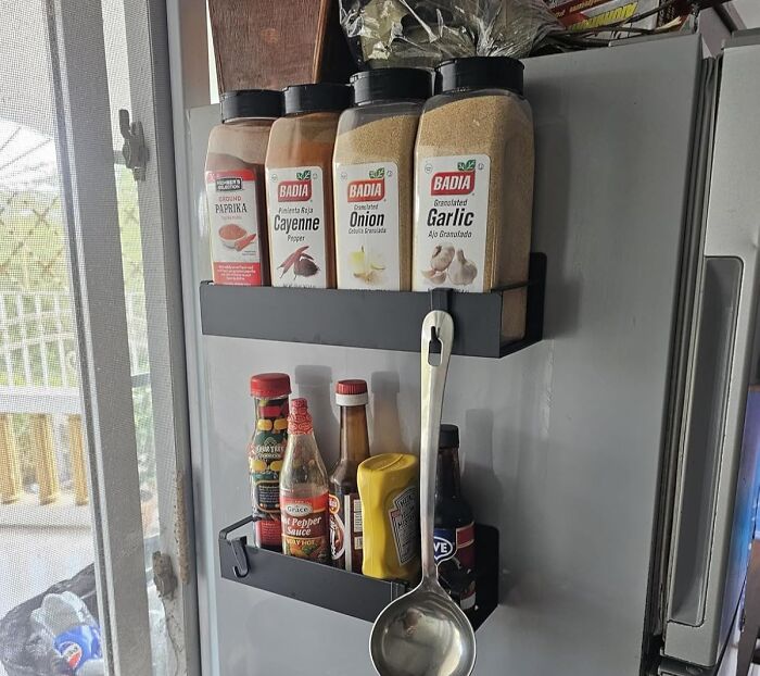 Magnetic spice racks on fridge door holding spices and sauces, showcasing early Prime Day deals on kitchen organizers.