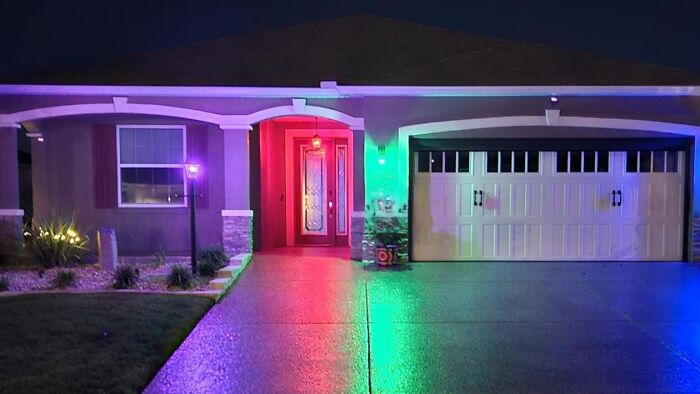 Modern house exterior at night with colorful lighting, showcasing early Prime Day deals ambiance and festive atmosphere.