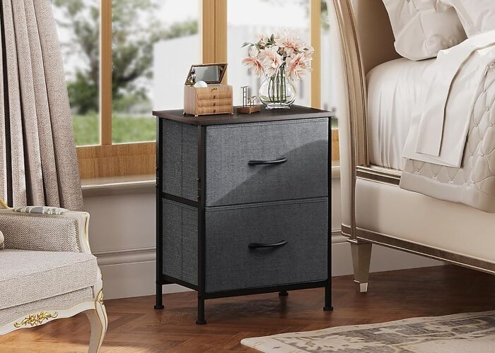 Modern bedside table with fabric drawers next to a bed, showcasing early Prime Day deals for stylish bedroom furniture.