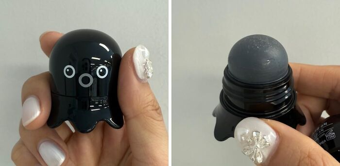 Hand holding a quirky gem shaped like a black octopus with a roller ball for brightening your day unexpectedly.