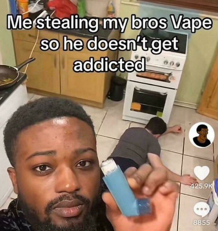 Man holding a vape with a person lying on the floor in a kitchen, showing absurd internet lies humor.