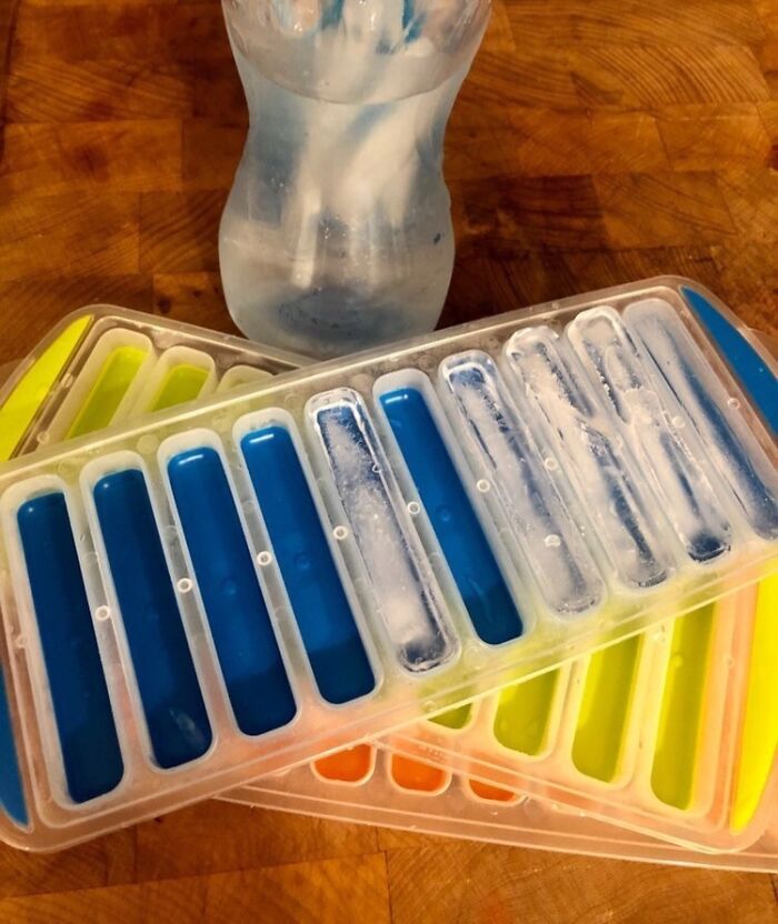 Ice pops molds filled with colorful juice and frozen, illustrating summer annoyances solutions.