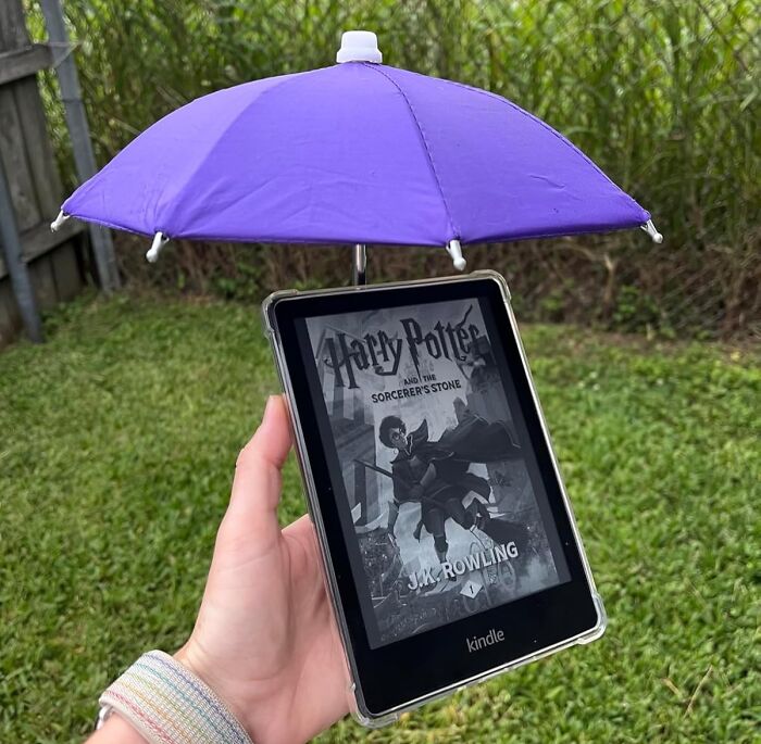 Kindle with purple umbrella attachment held outdoors, illustrating ways to fight back summer annoyances and stay protected.