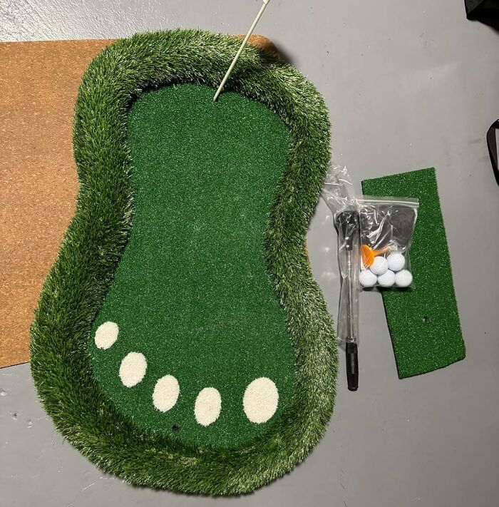 Miniature indoor putting green with footprint design and golf accessories, a novelty find that looks like a joke but is genius.