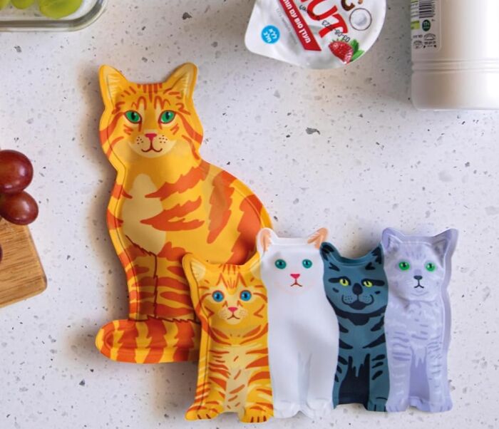 Colorful cat-shaped novelty finds on a kitchen countertop showcasing unique and low-key genius design ideas.