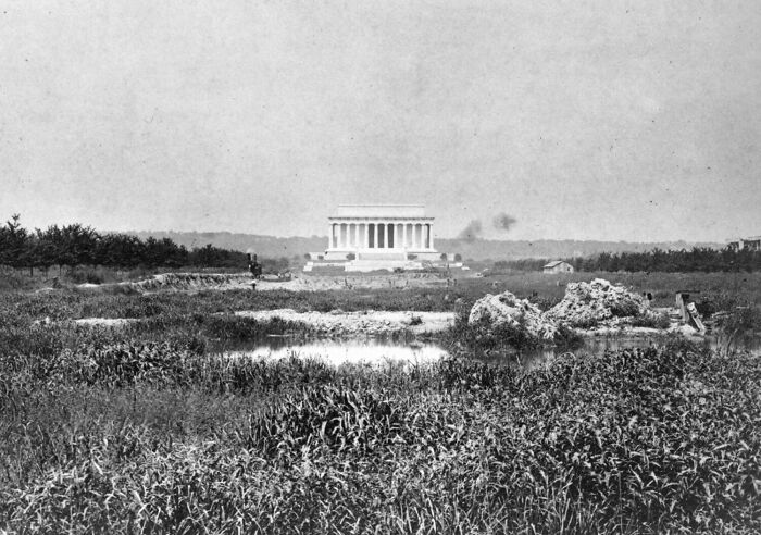 Historic view of a famous landmark captured from an unexpected angle showing surrounding natural landscape.