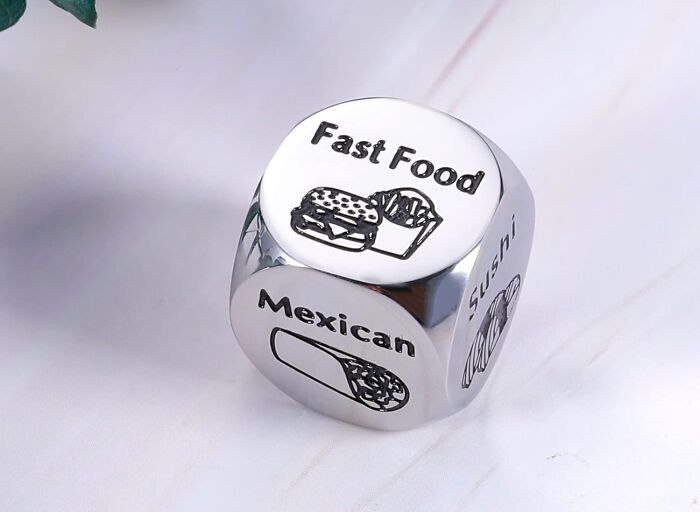 Silver decision dice showing food options like fast food, Mexican, and sushi, featured in halftime show star products.