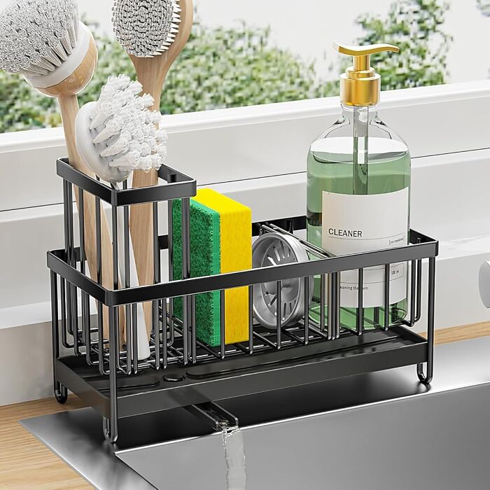 Organized kitchen sink caddy holding cleaning brushes, sponge, and soap dispenser, showcasing star performers of the year's halftime show.
