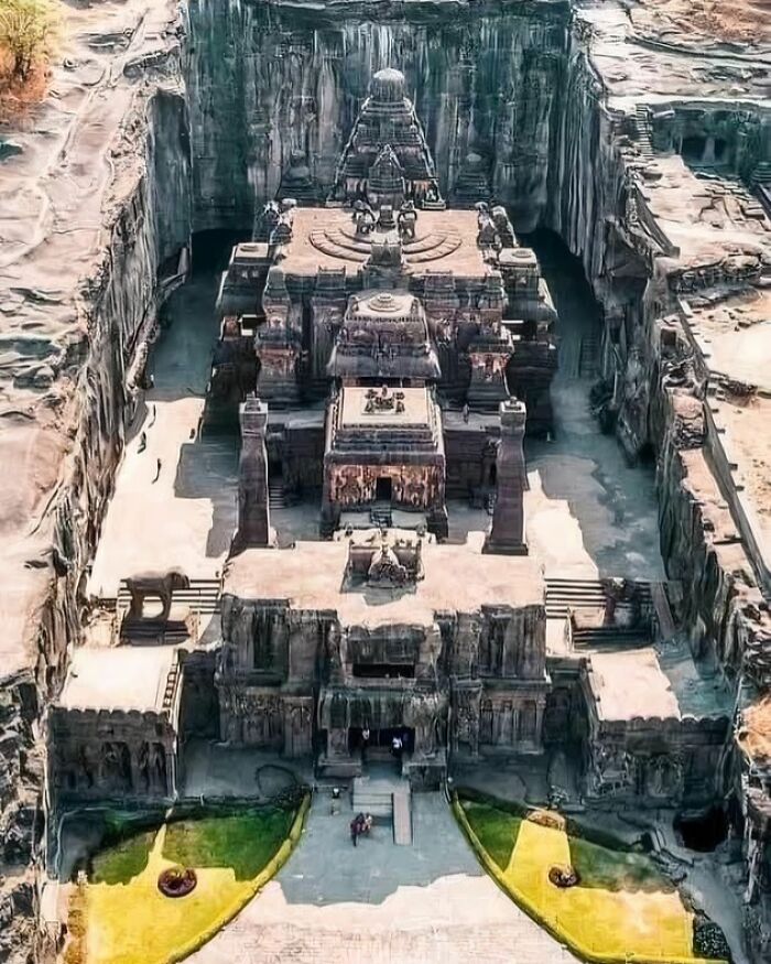 Aerial view of an ancient rock-cut temple showcasing detailed carvings and architecture in archaeology world.