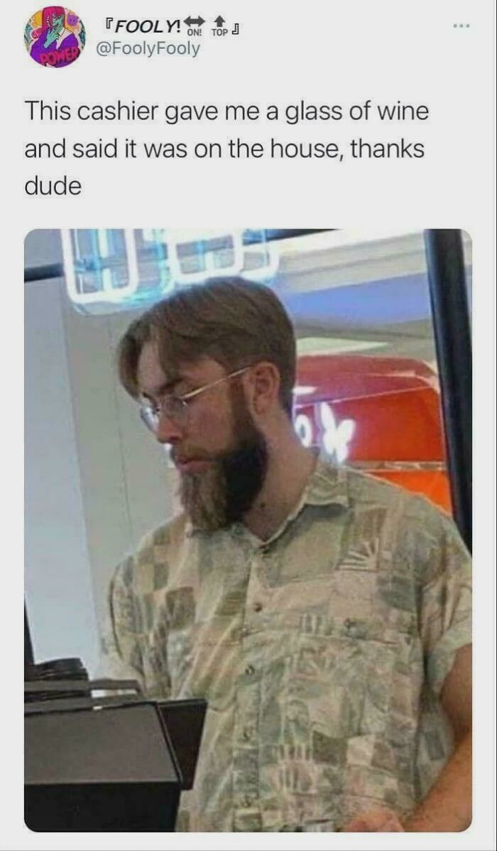 Man with glasses and beard standing at a counter, paired with meme text about a cashier giving wine on the house explain the joke.