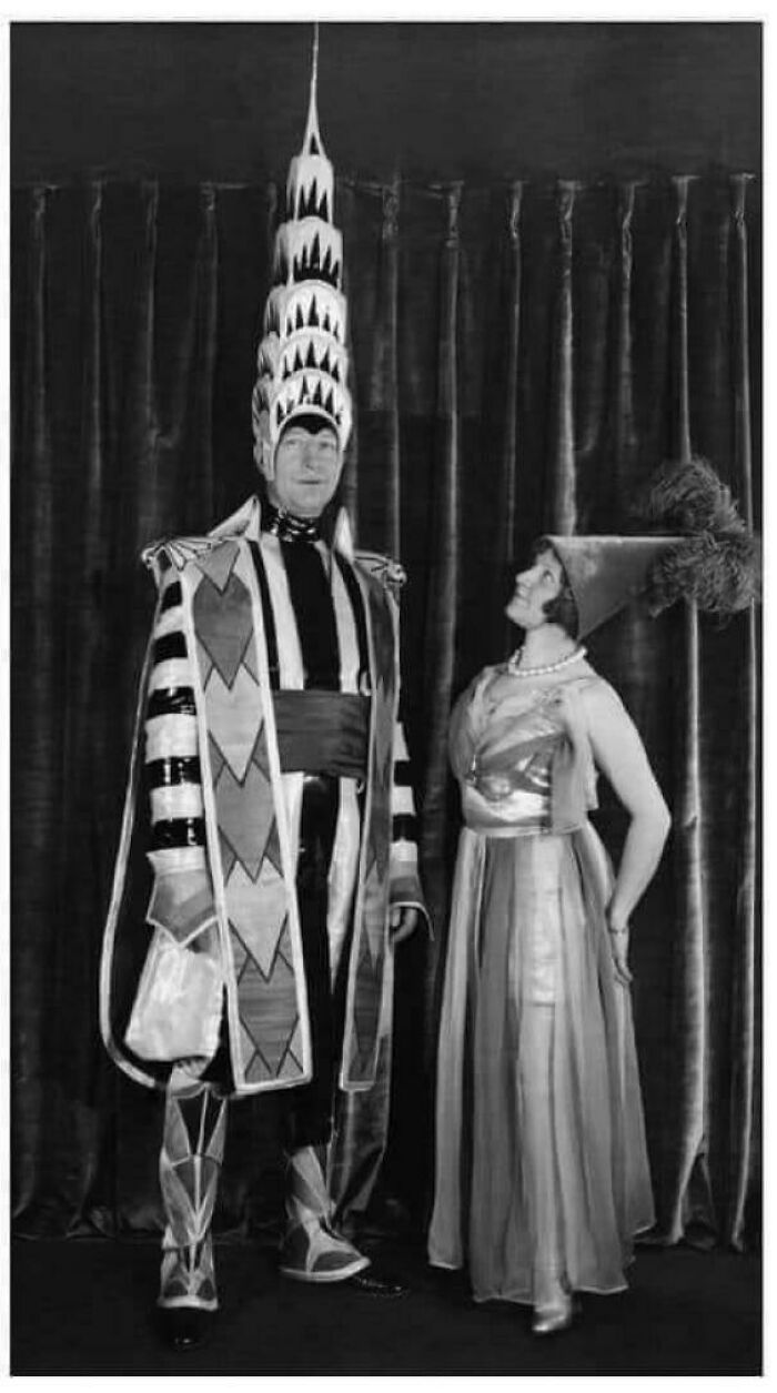 Black and white vintage photo of a man and woman in ridiculous costumes from the past that would never fly today.