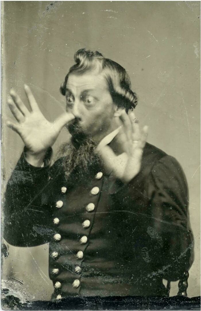 Vintage black and white photo of a man making a silly face in a ridiculous pic from the past that would never fly today.