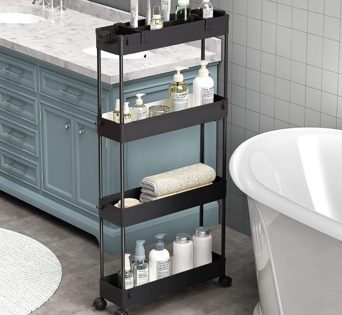 Slim black rolling storage cart with toiletries and towels, a genius kitchen Prime Day find for organized spaces.