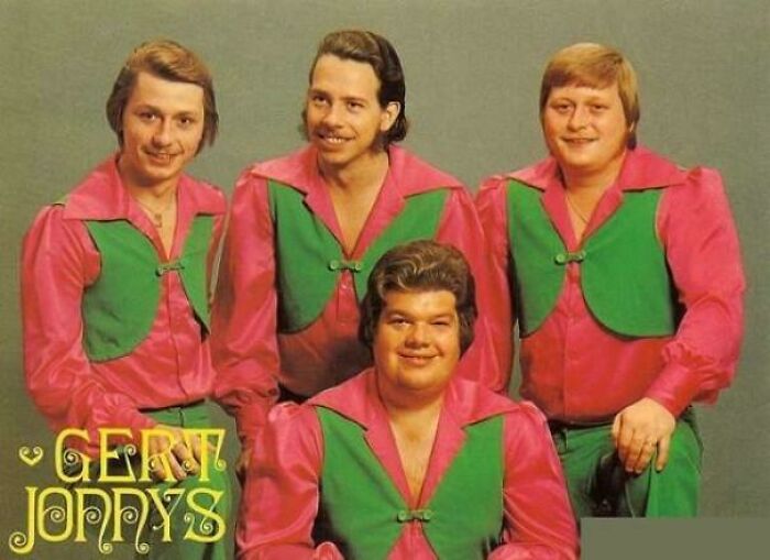 Four men in matching retro pink and green outfits posing for a vintage ridiculous pics from the past photo.