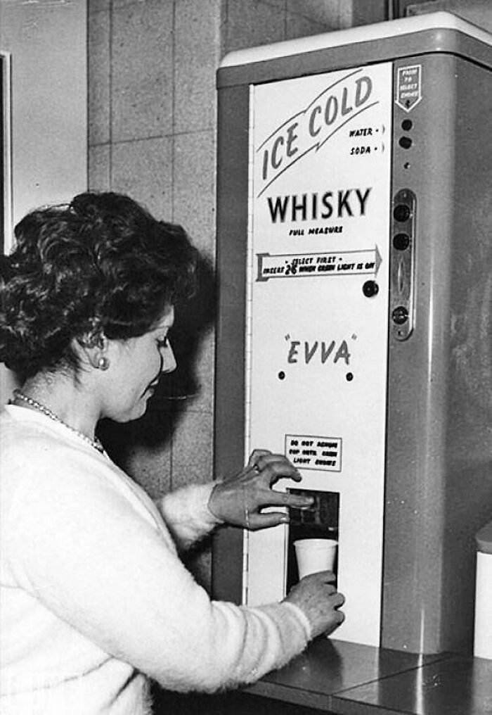 Woman using a vintage whisky vending machine, showcasing a ridiculous pic from the past that would never fly today.