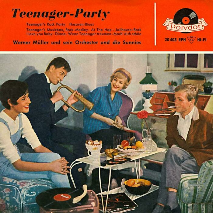 Group of teenagers having a retro party with vintage music and playful instruments in a cozy living room setting.