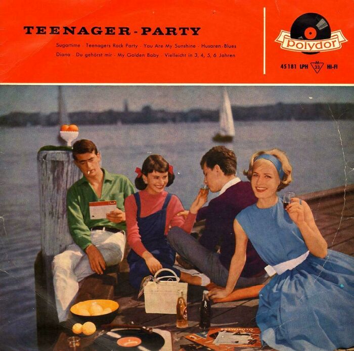 Vintage teenager party by the water with 1960s style clothing, vinyl records, and casual socializing, a ridiculous pic from the past.