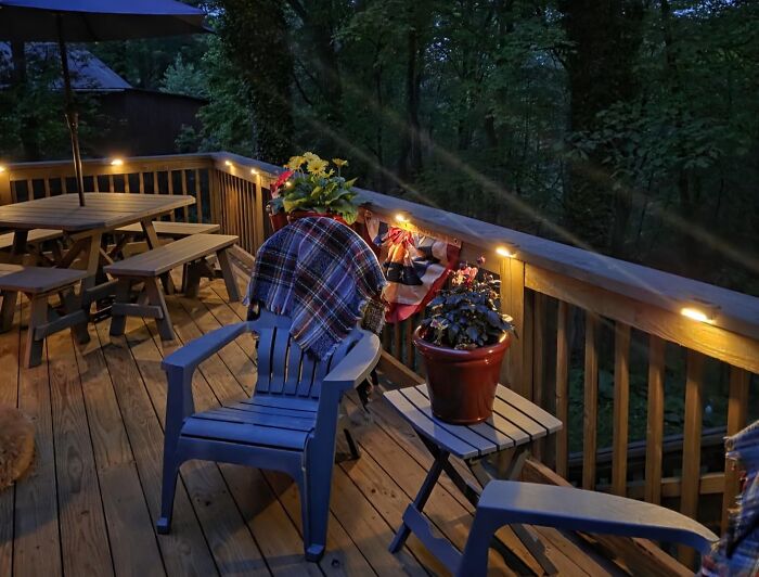 Cozy outdoor deck with string lights, Adirondack chairs, and plants, featuring popular Amazon wishlist finds for home decor.