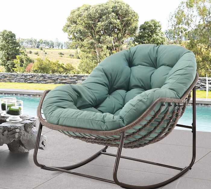 Outdoor rocking chair with green cushion near pool and scenic backyard, one of the top Amazon wishlist finds.