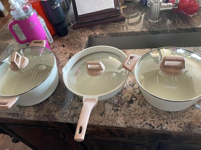 Set of beige ceramic cookware with glass lids and wooden handles on a granite kitchen countertop Amazon wishlist finds