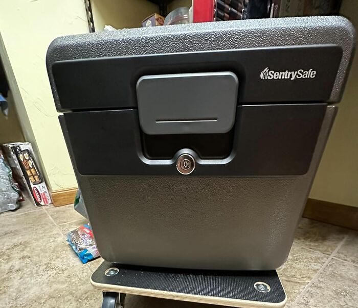 Black SentrySafe lockbox with keyhole on a tiled floor, one of the popular finds on Amazon wishlists.