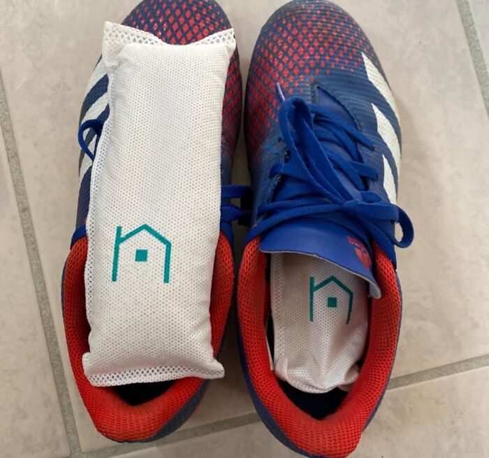 Blue and red sneakers with white cushioned inserts featuring a teal house logo, promoting comfort and style in beauty buys.