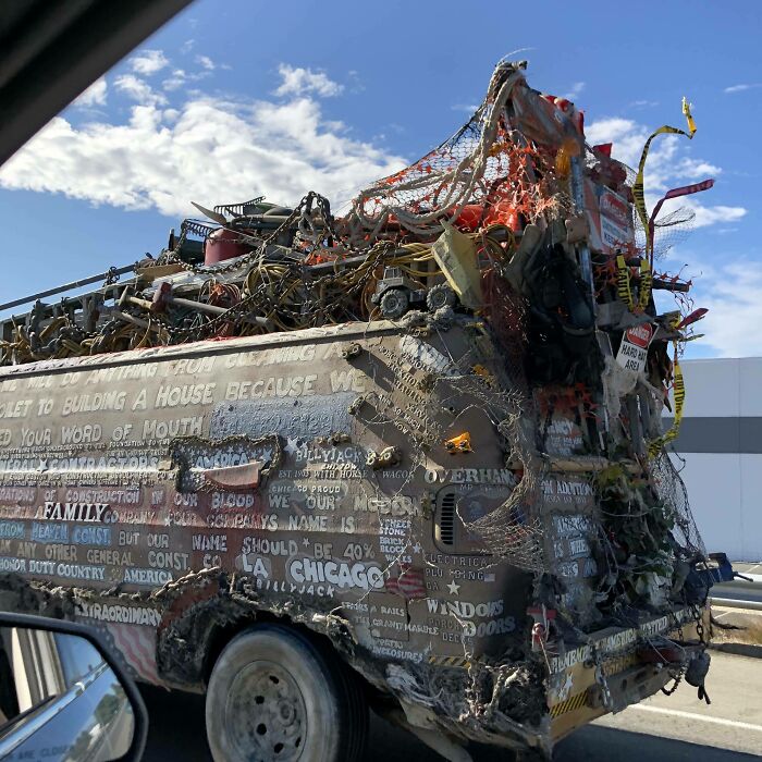 Outrageous car mods featuring an extensively decorated van covered in chains, nets, and various objects on a sunny day.