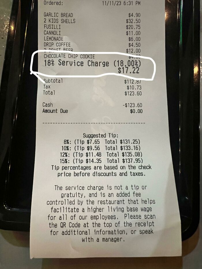 Receipt showing an 18% service charge fee highlighted, an example of ridiculous fees people have every right to be mad about.