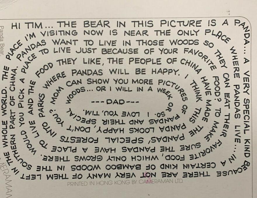 Curved perfect handwriting example on paper with a message about pandas and their natural habitat.