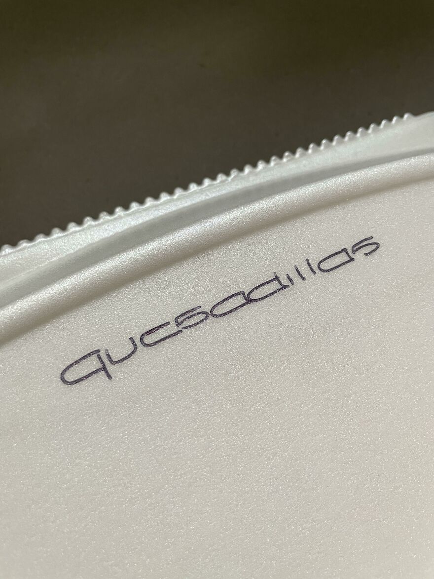 Close-up of a plastic surface with perfect handwriting spelling out an altered Adidas logo, showcasing perfect handwriting examples.