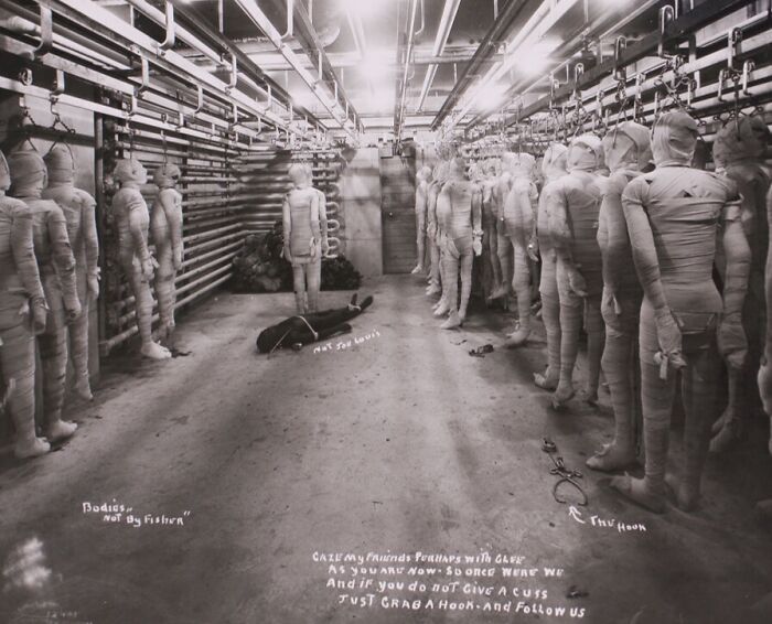 Rows of creepy wrapped mannequins in a dimly lit room, evoking unsettling photos from the past.